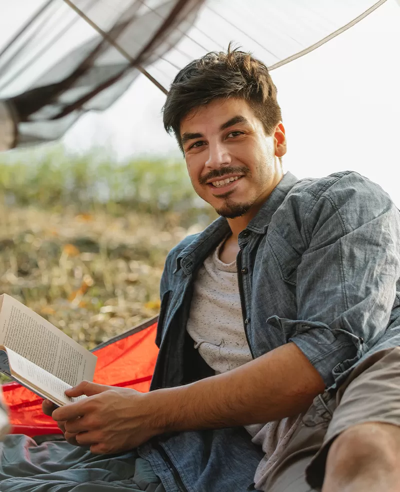  traveler resting in tent against lake